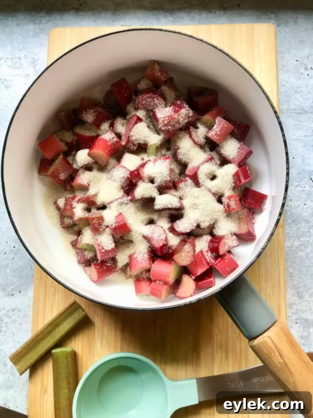 Rhubarb and sugar cooking in a saucepan for pie filling