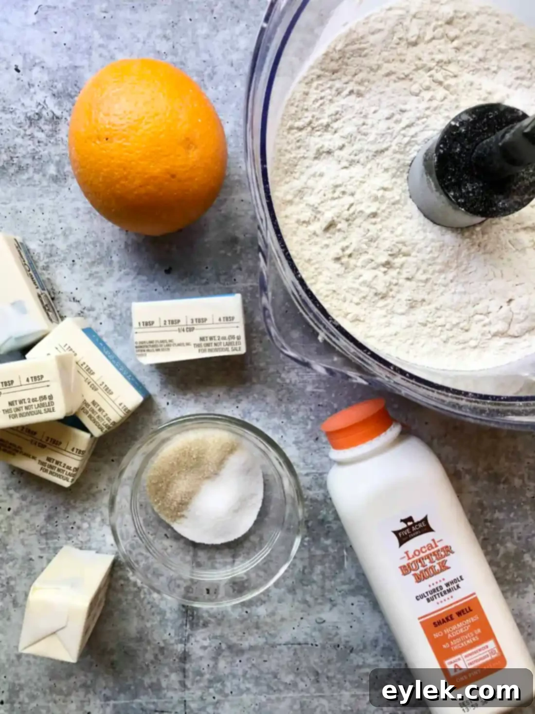 Ingredients for pie crust dough, including flour, butter, and buttermilk