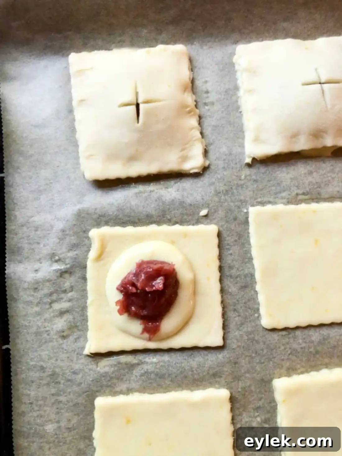 Cream cheese and rhubarb filling being placed on dough squares