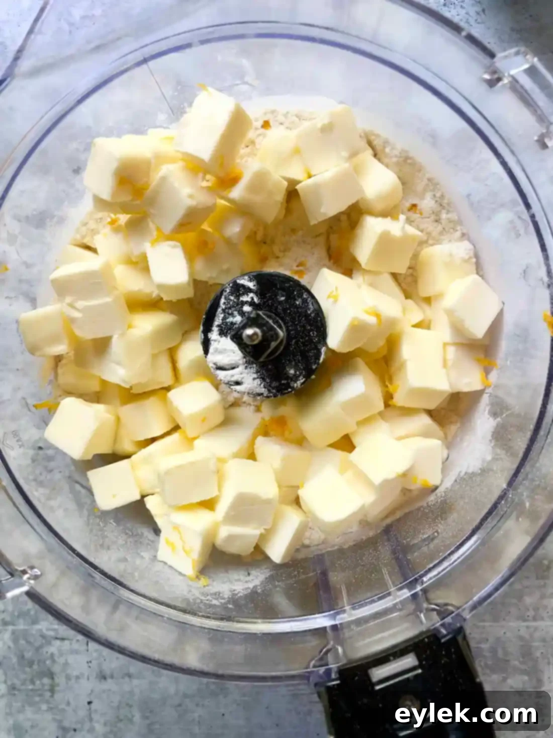 Buttermilk being added to pie crust dough in a food processor