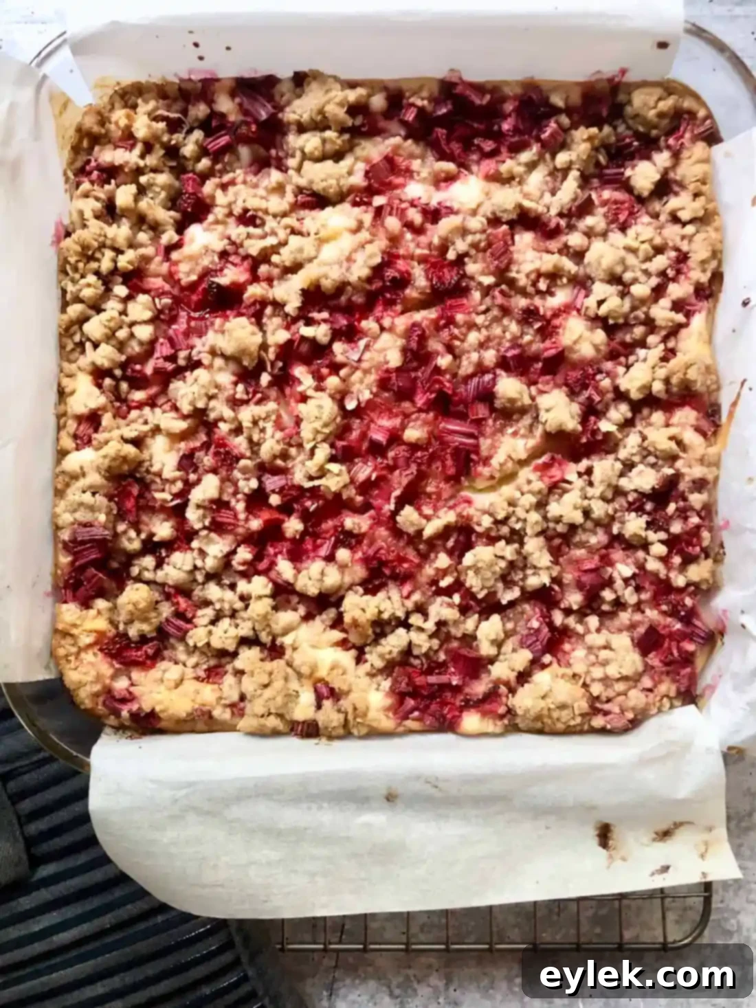Strawberry Rhubarb Cheesecake Squares cooling on a wire rack.