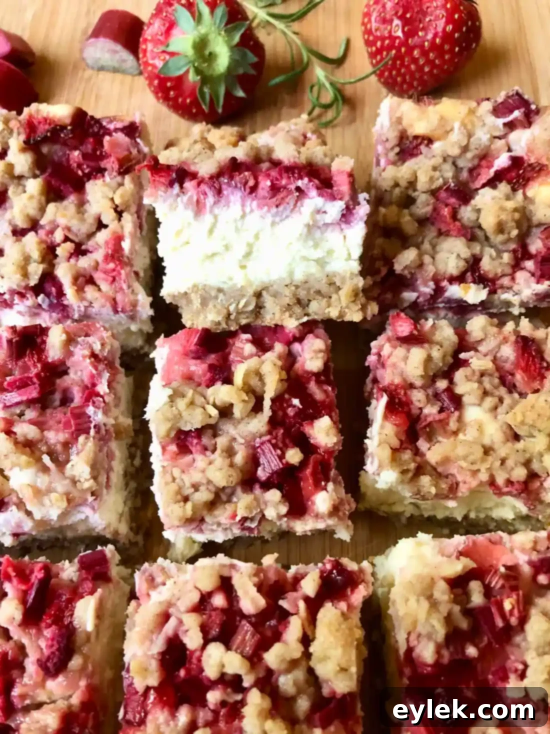 A slice of Strawberry Rhubarb Cheesecake Square, showing the distinct layers.