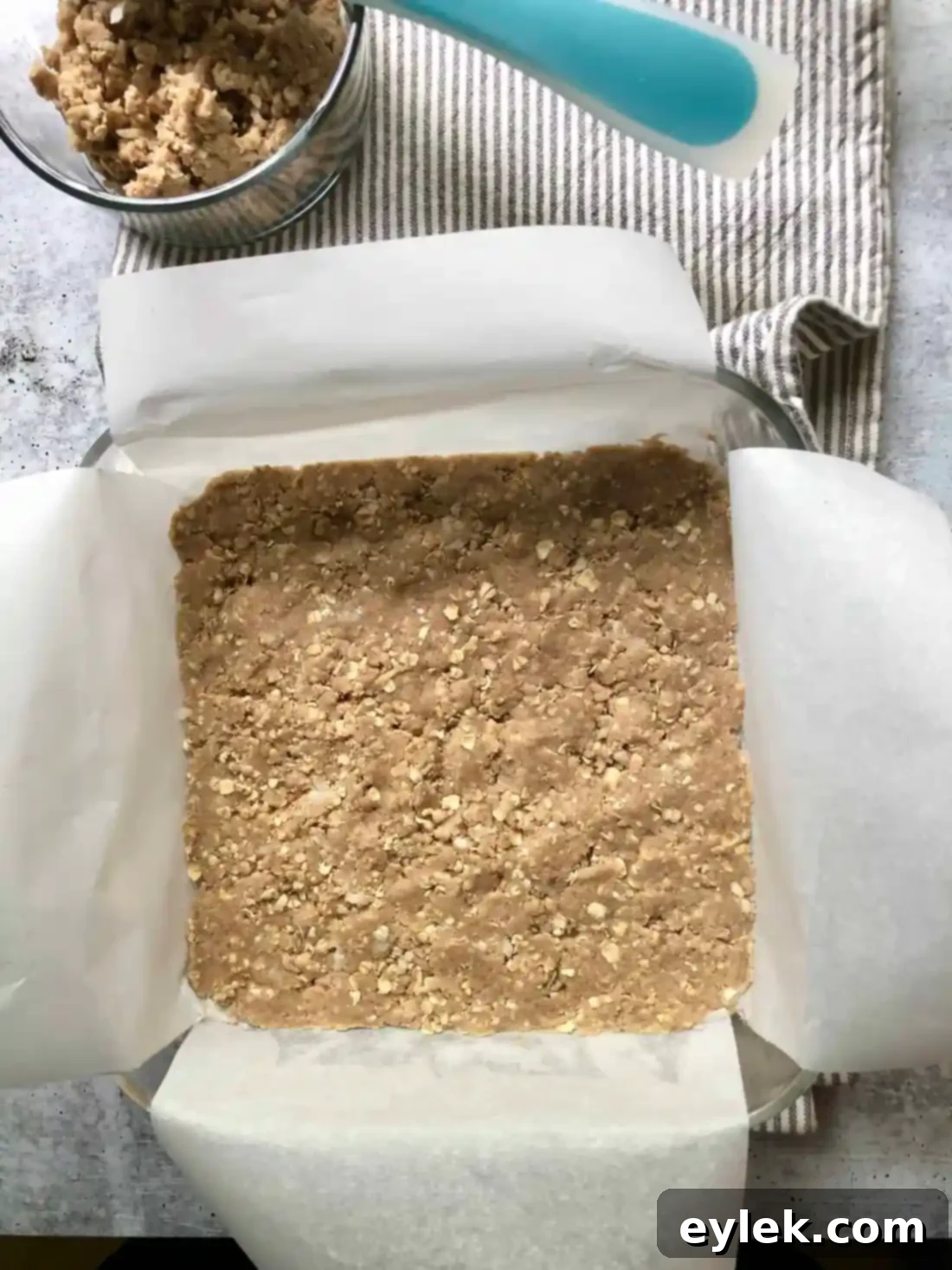 The partially baked coconut oat crumble crust, slightly golden.