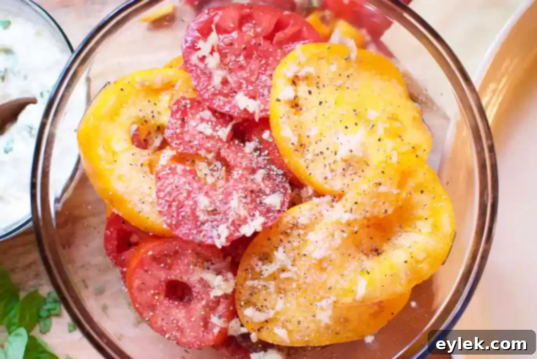 Seasoned heirloom tomatoes ready for layering in gratin lasagna
