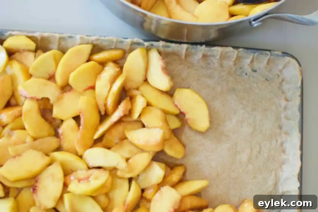 The bottom pie crust pressed into a rectangular baking sheet.
