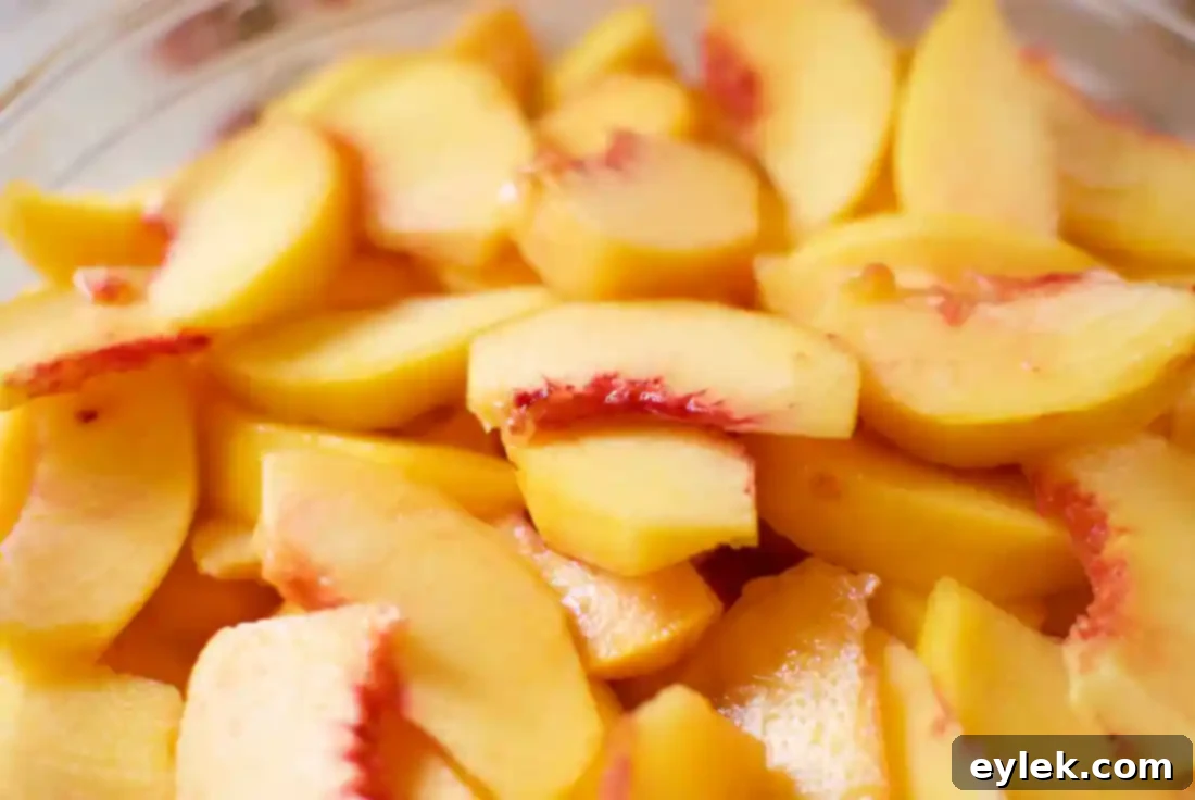 A large quantity of peeled and sliced peaches.