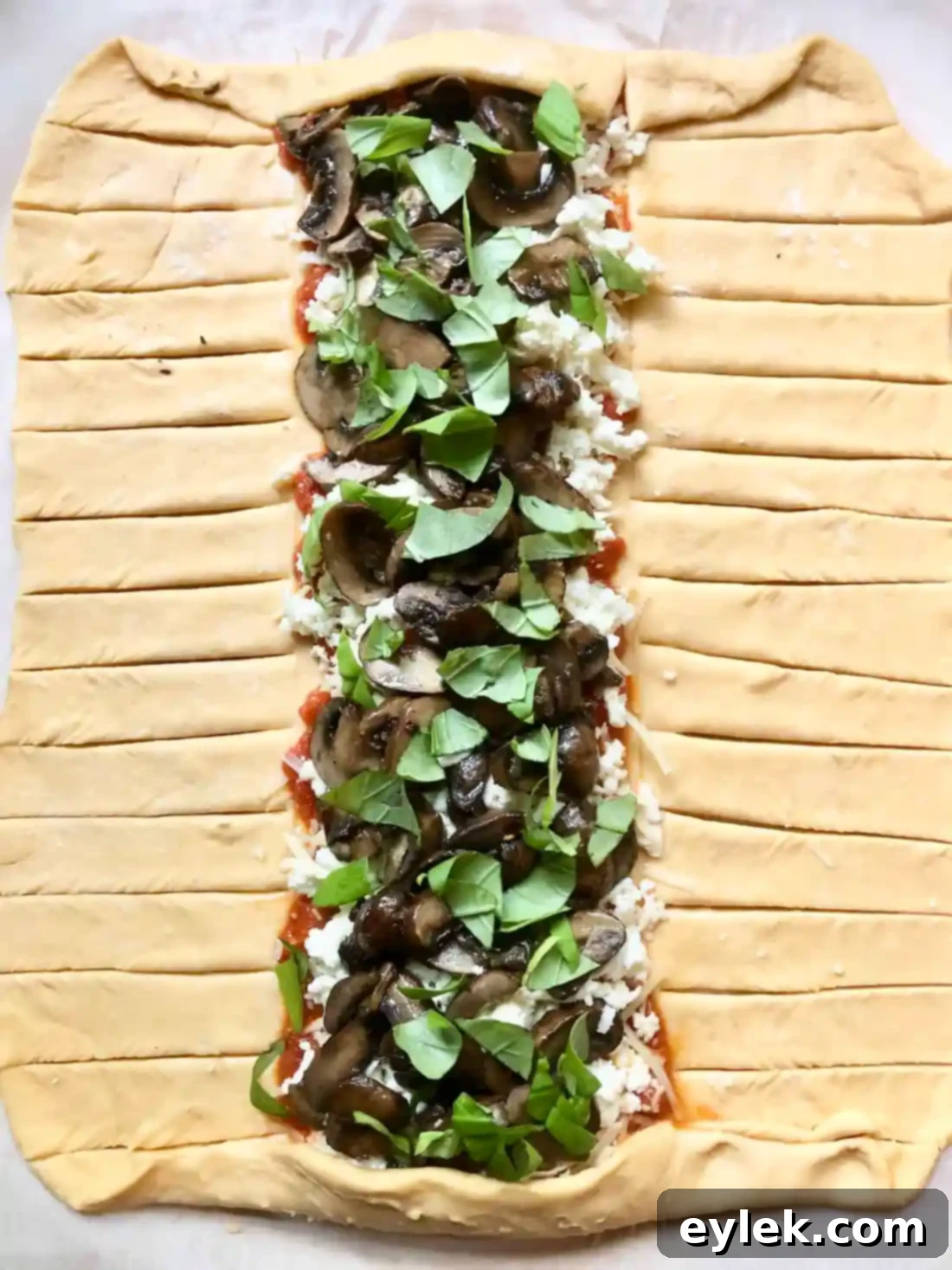 Dough strips cut for braiding the Pizza Braid