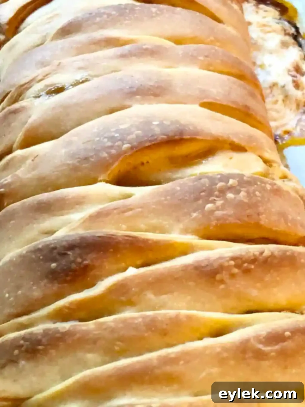Slicing the baked Pizza Braid with Basil & Mushrooms