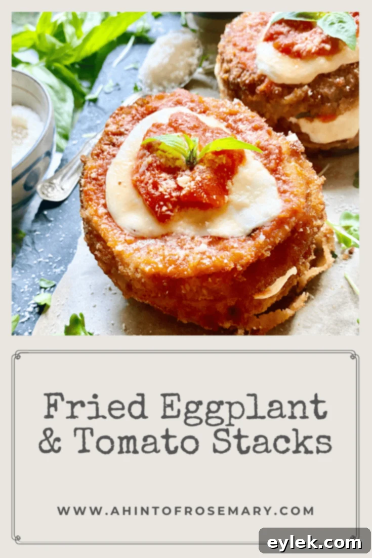 Beautifully plated Fried Eggplant & Tomato Stacks, showcasing melted cheese and fresh basil, ready to be enjoyed.