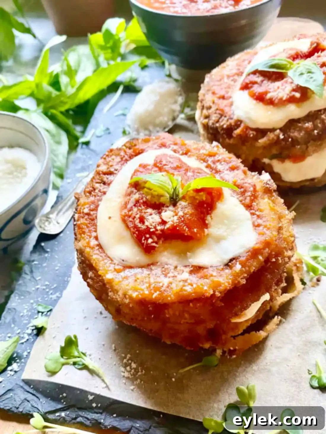 Two servings of Fried Eggplant & Tomato Stacks, perfectly layered and garnished.