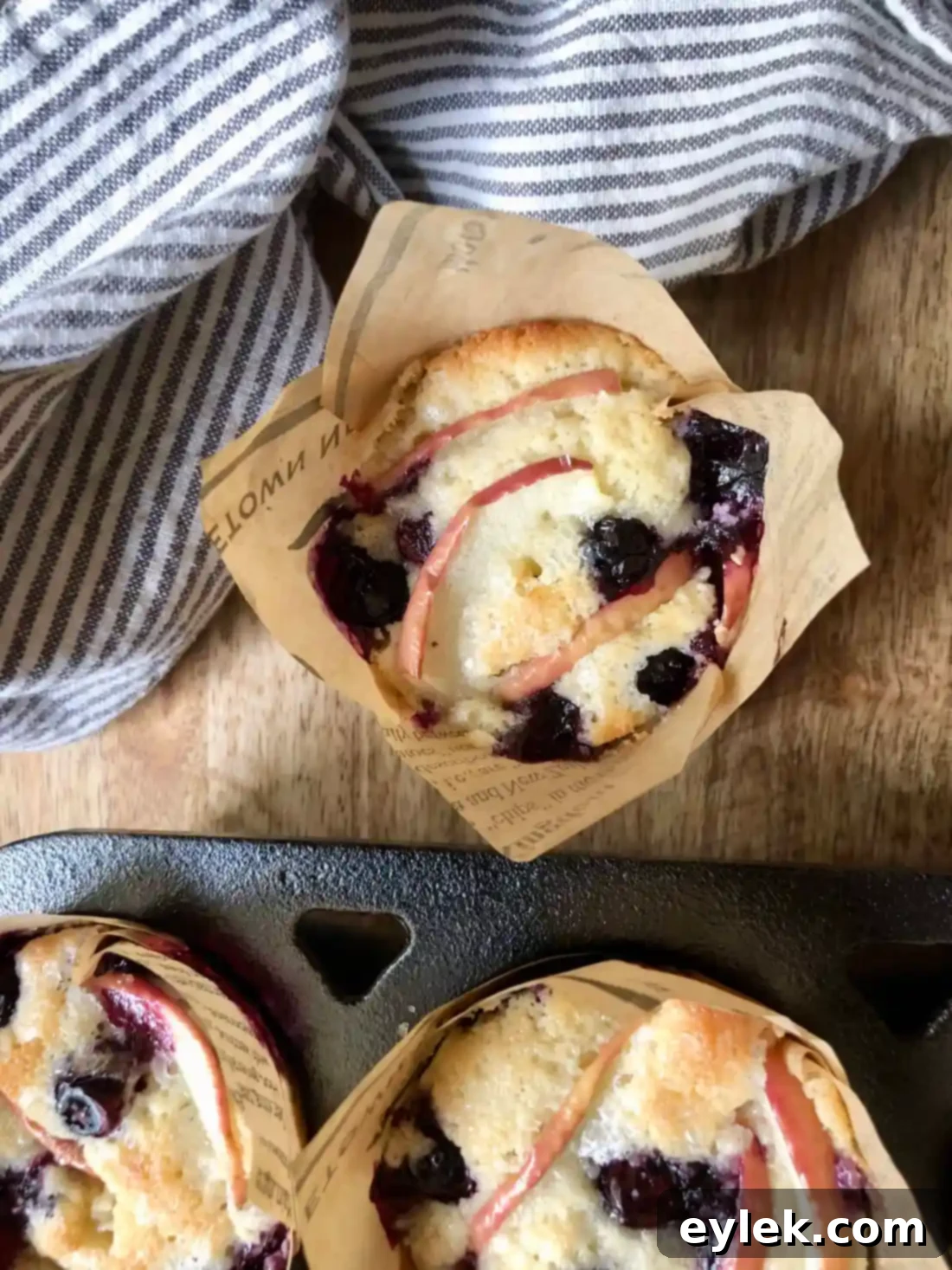 Cooling fluffy apple blueberry cupcakes on a rack
