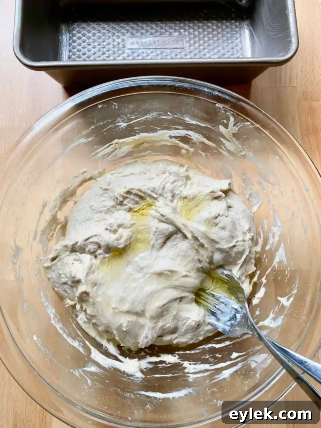 Never-Fail Sandwich Bread - Deflating dough with forks