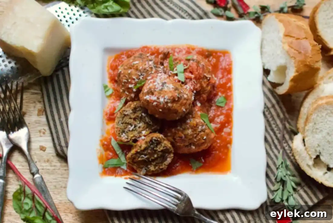 Rustic table setting with a bowl of Beef and Chard Meatballs and a glass of red wine