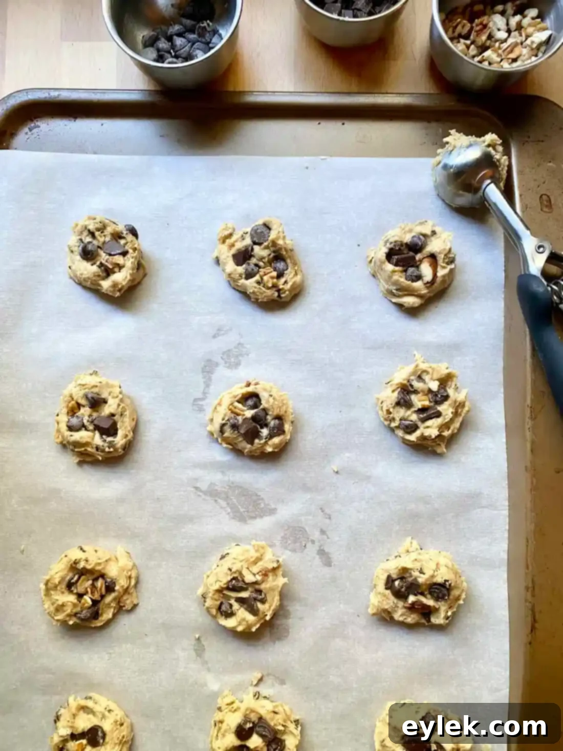 Scooped pumpkin chocolate chip cookie dough on baking sheet