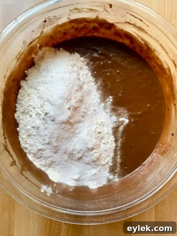 Cocoa powder being added to pumpkin mixture