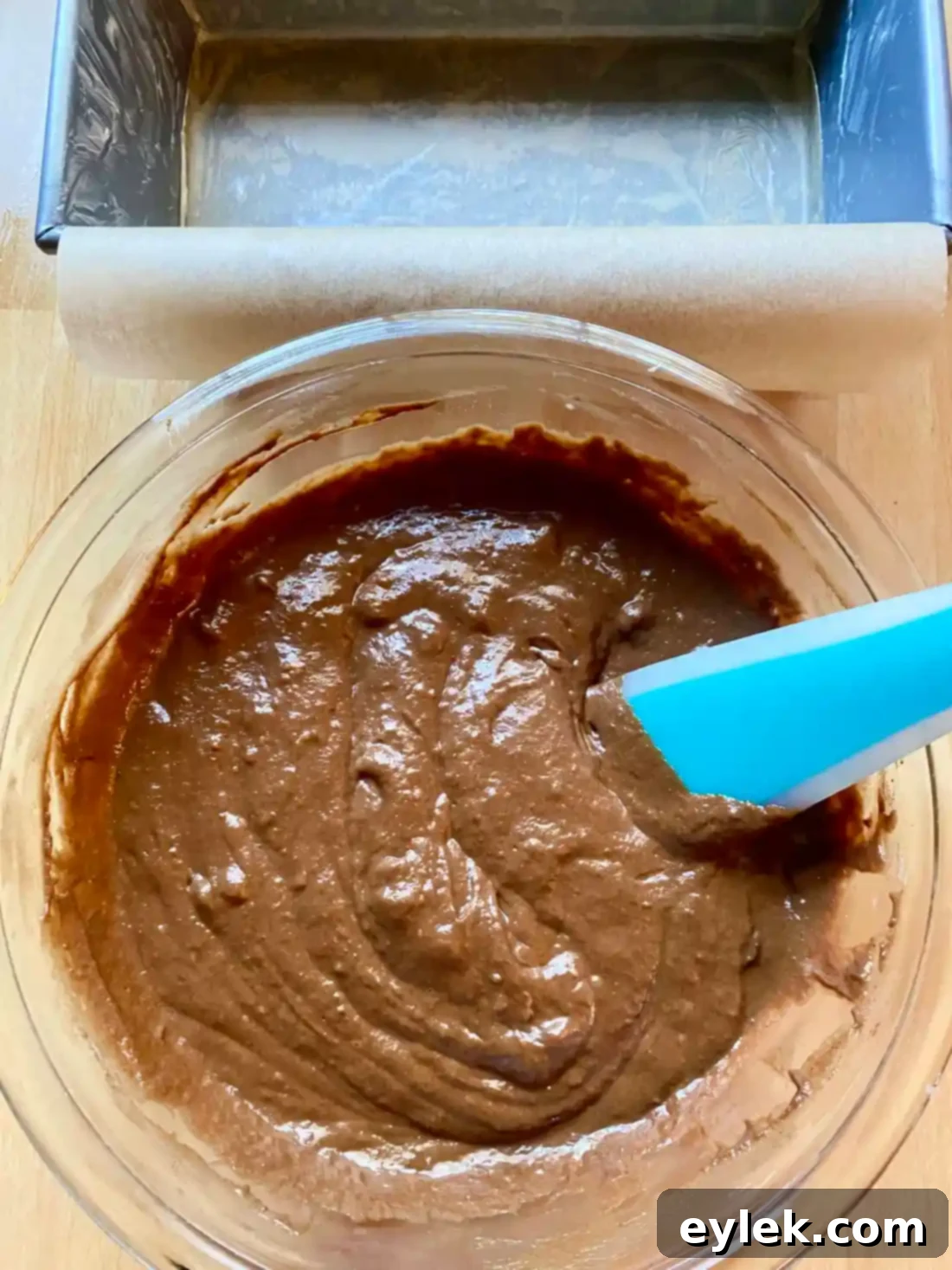 Cake batter being poured into loaf pan