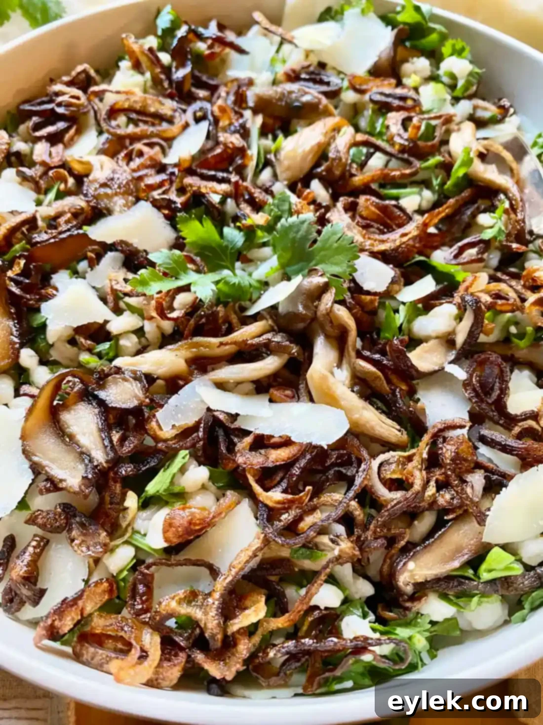 Close-up of Herby Barley Salad with Buttery Mushrooms in a bowl, garnished with fresh herbs