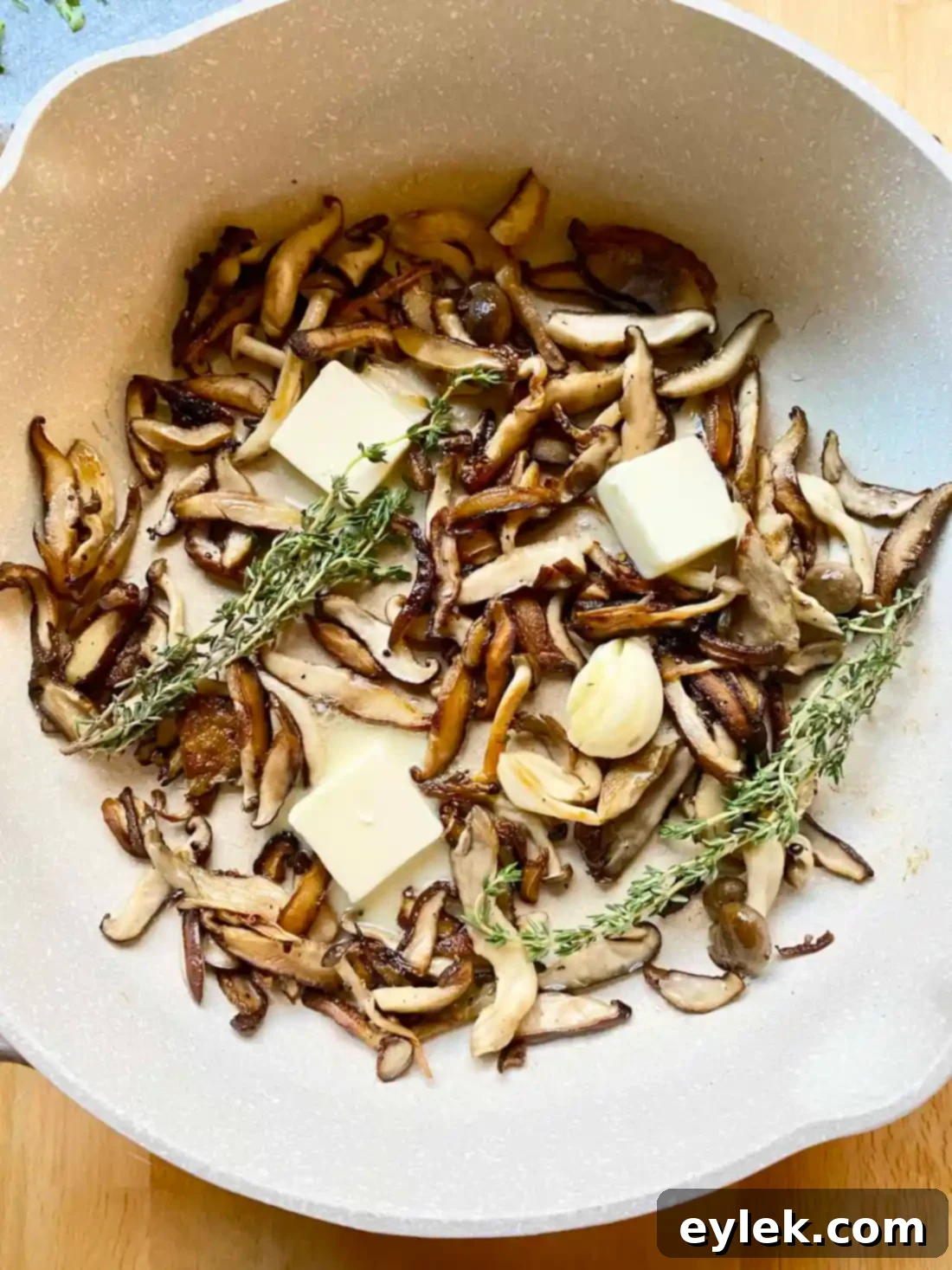 Sautéed wild mushrooms with salt and pepper in a skillet