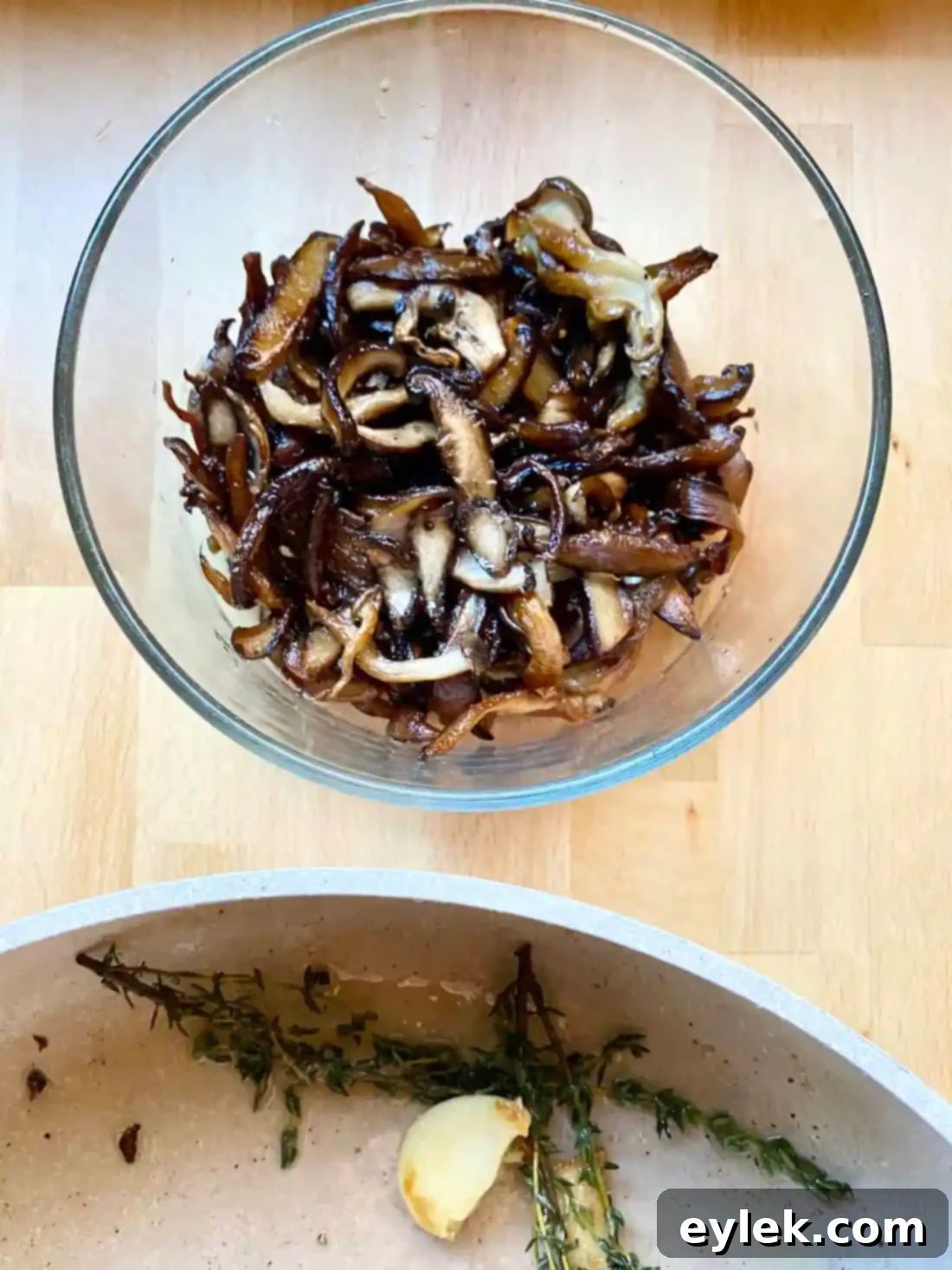 Sautéed wild mushrooms removed from skillet, leaving thyme and garlic behind