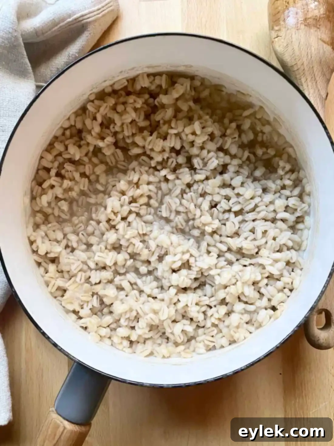 Close-up of pearl barley cooking in salted water in a pot