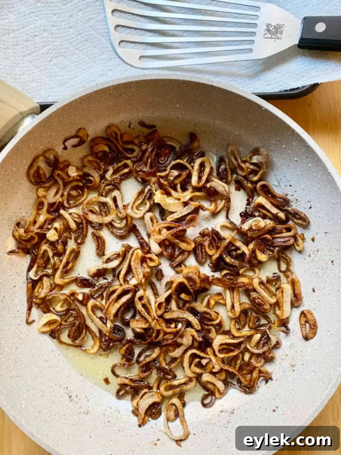 Golden brown crispy fried shallots draining on paper towels