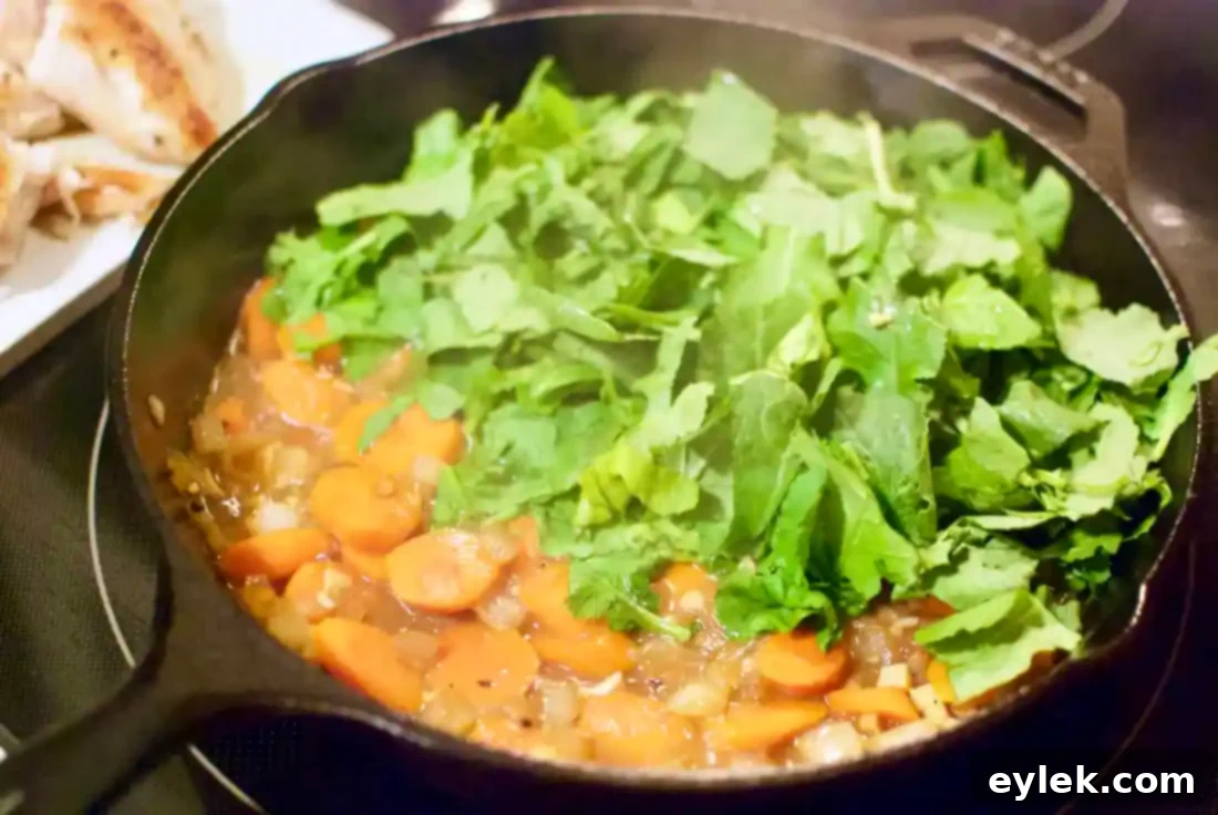 Raw chicken breasts seasoned in a skillet for pot pie