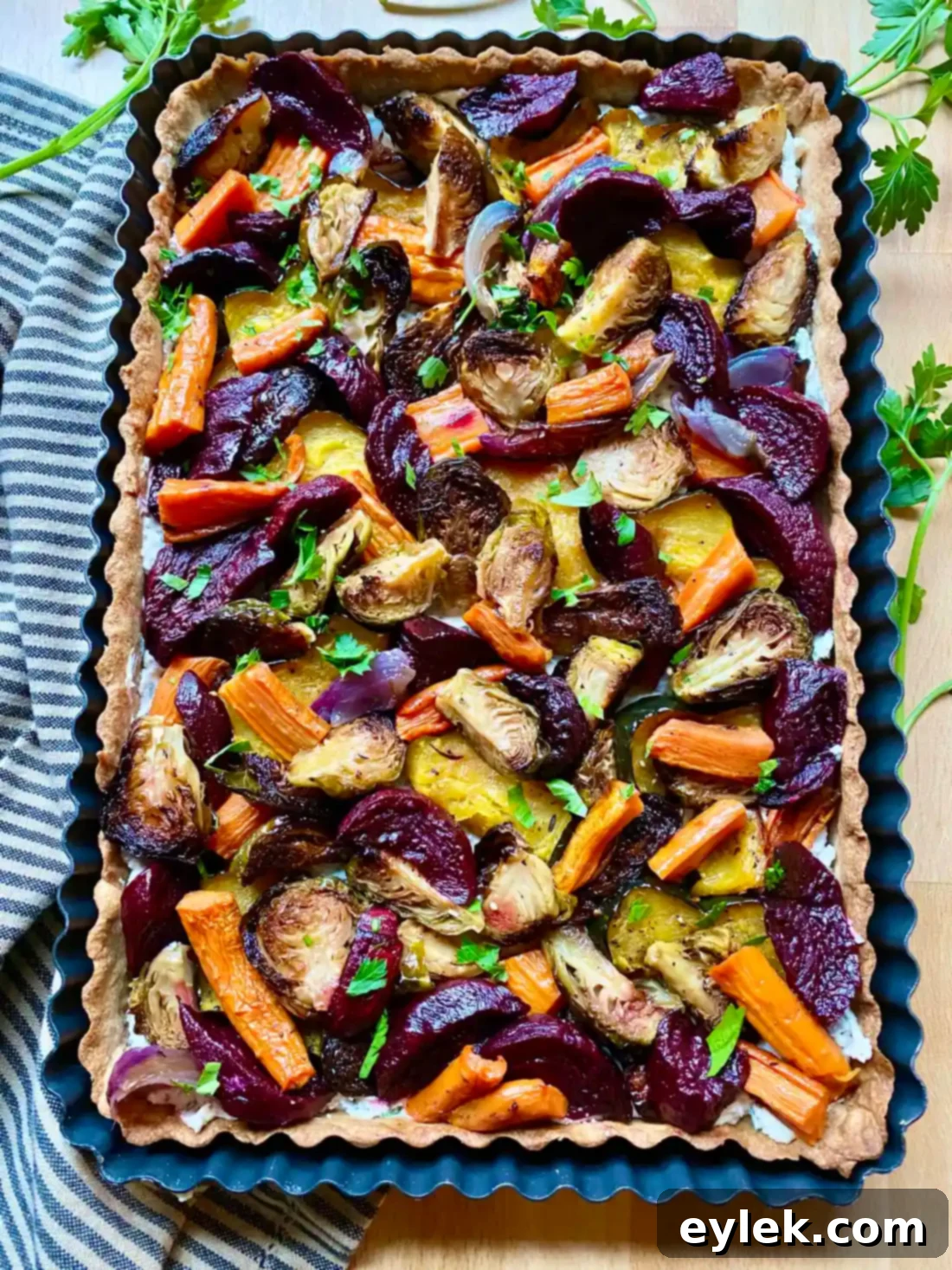Roasted vegetables arranged on tart