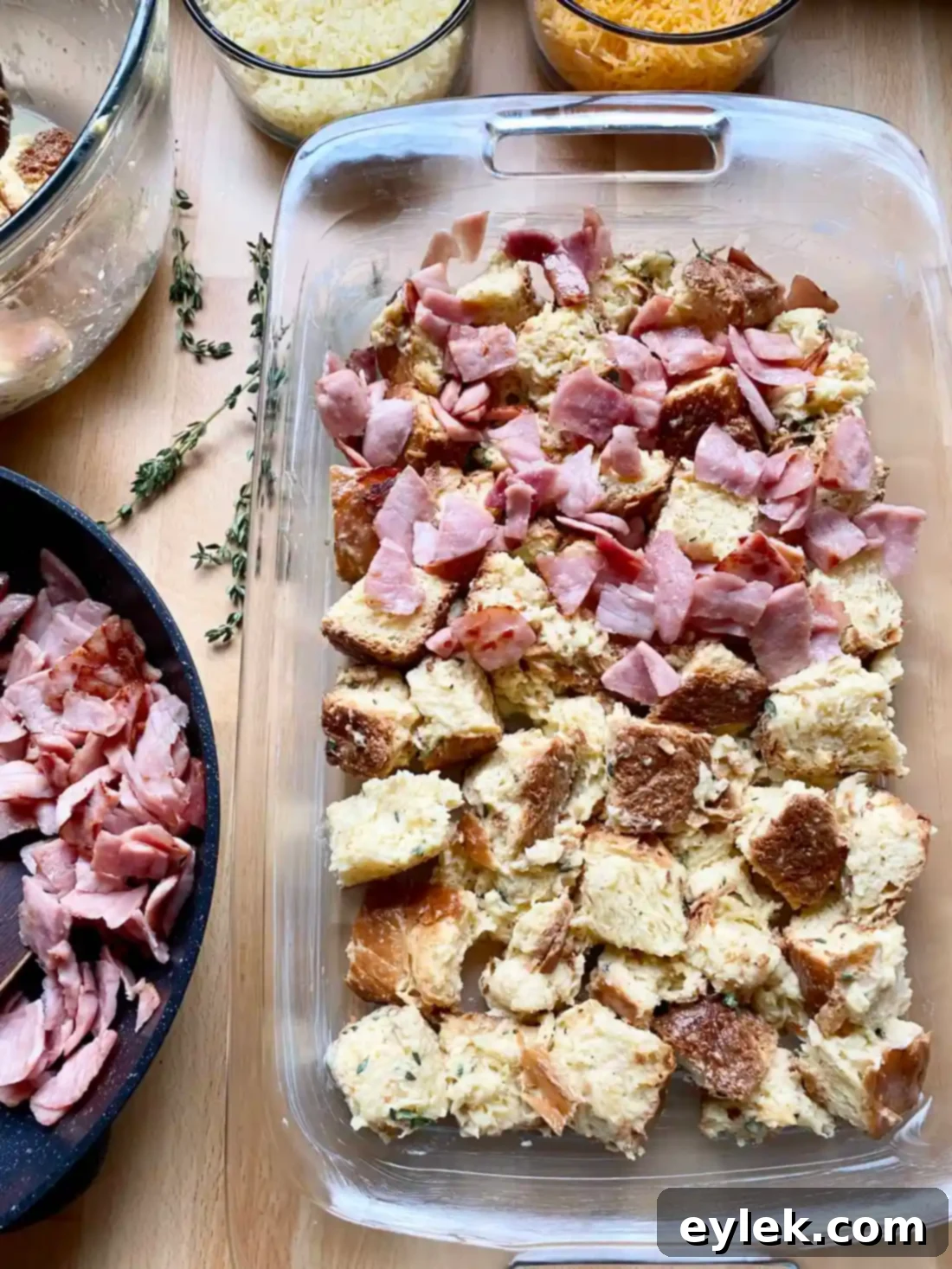 Layered savory bread pudding before baking