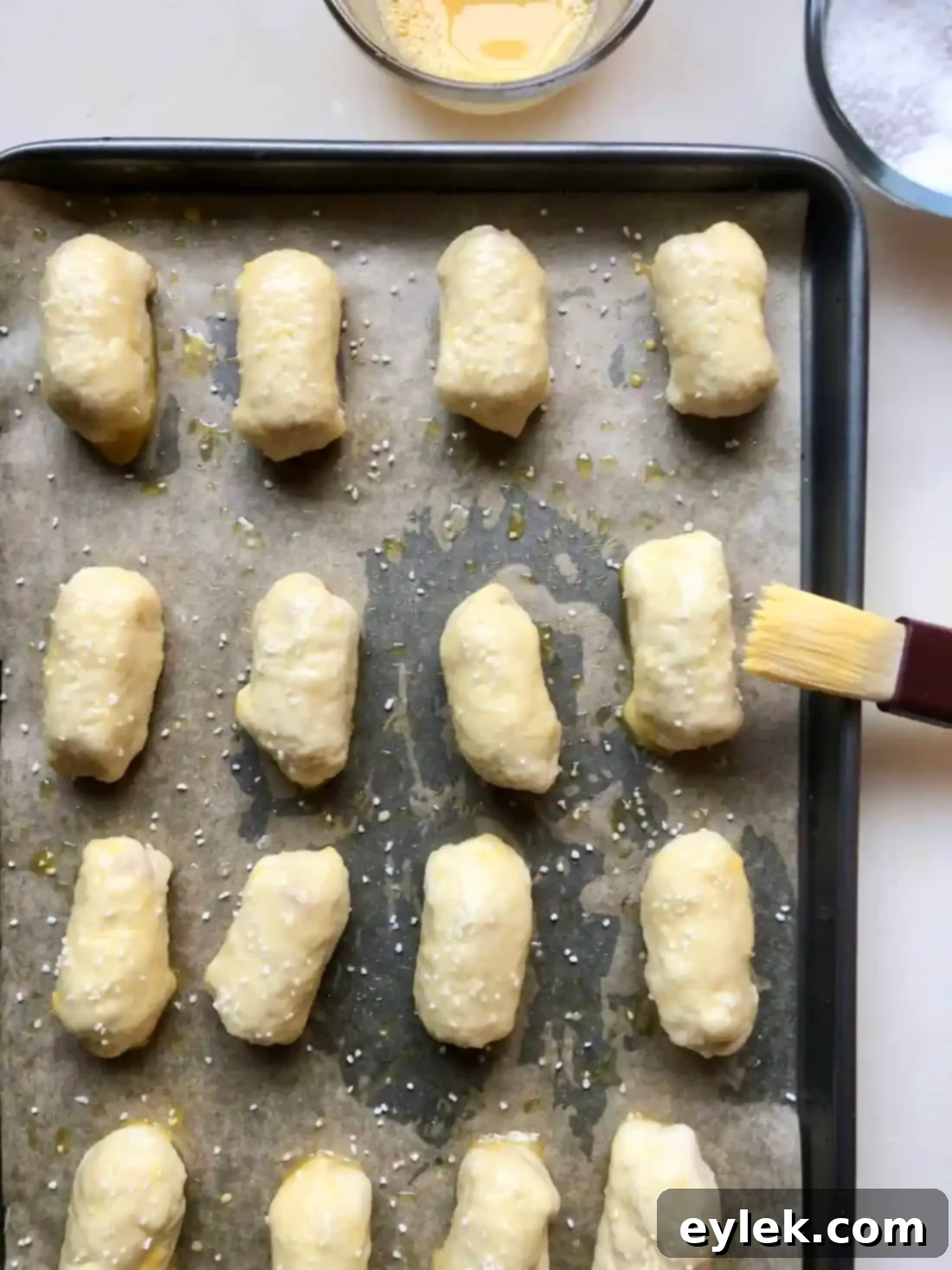 Pretzel bites on baking sheet, brushed with egg wash and salt