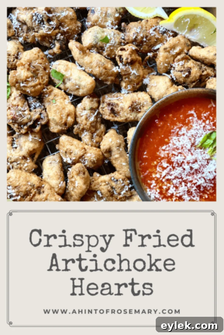 Crispy Fried Artichoke Hearts on a serving board with dipping sauce and lemon