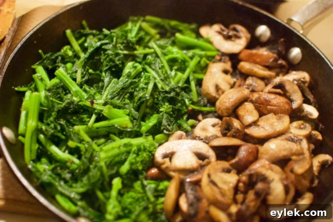 Assorted cooked vegetables including broccoli rabe and mushrooms.