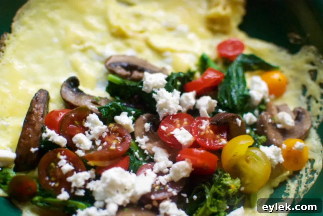 A healthy omelet with vegetables and feta cheese, served with roasted cauliflower.