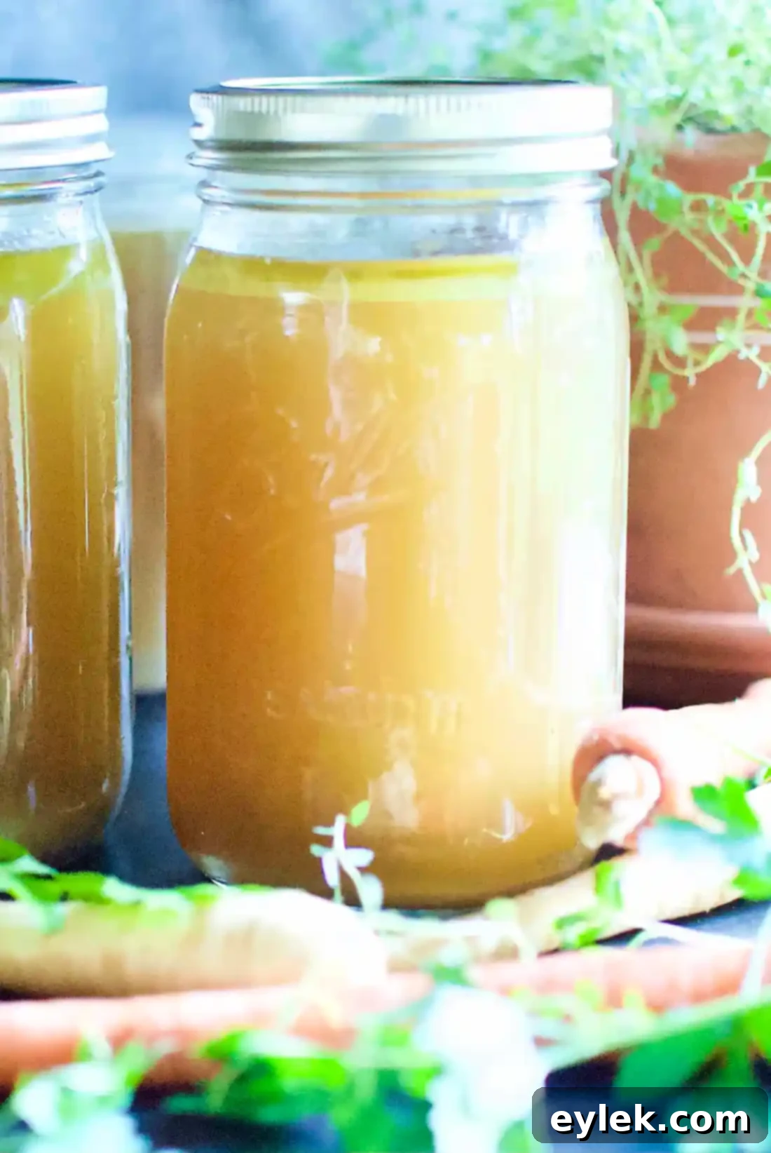 Stacked jars of Ina Garten's Homemade Chicken Stock ready for storage
