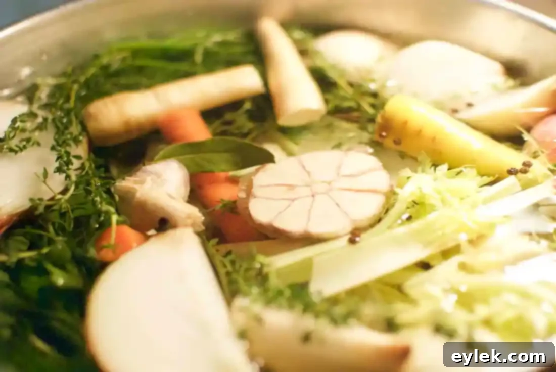 Fresh vegetables like carrots, celery, parsnips, and onions prepared for chicken stock