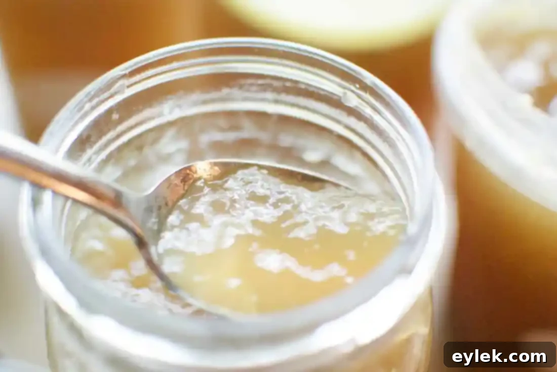 Ina Garten's homemade chicken stock after cooking, showing golden liquid