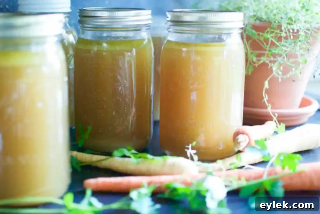Jars of freshly made Ina Garten's homemade chicken stock on a counter