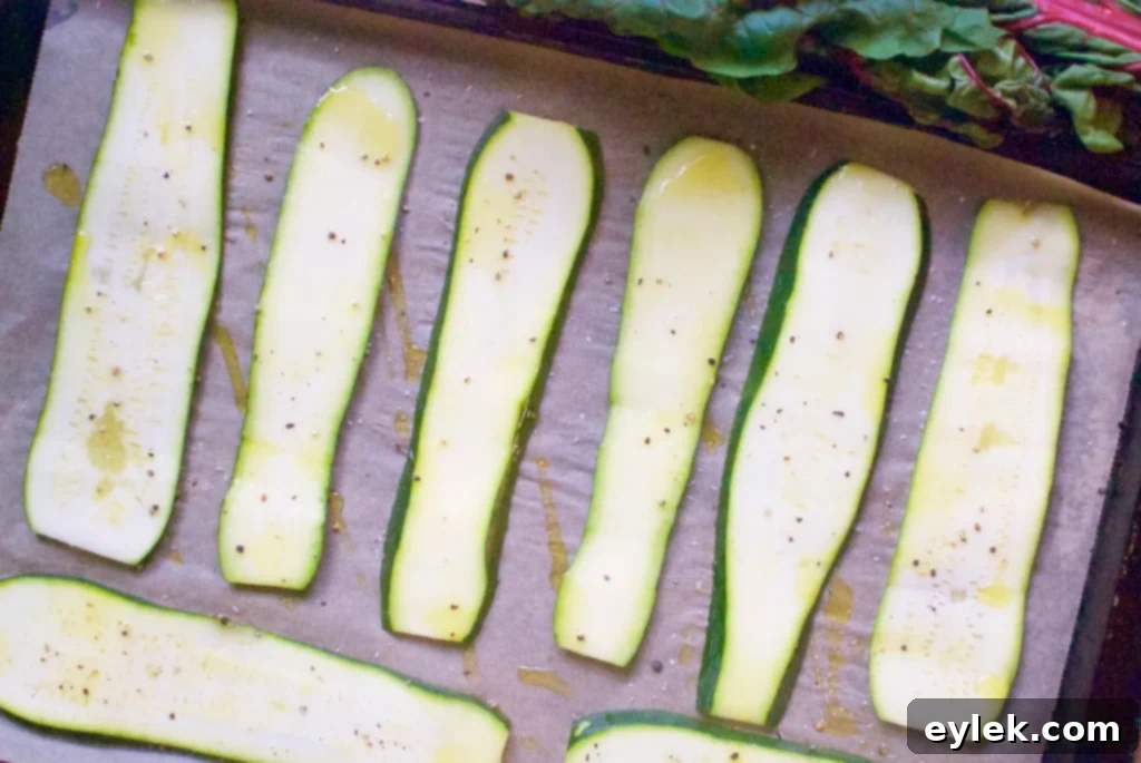 Thinly sliced zucchini arranged on a baking sheet for involtini