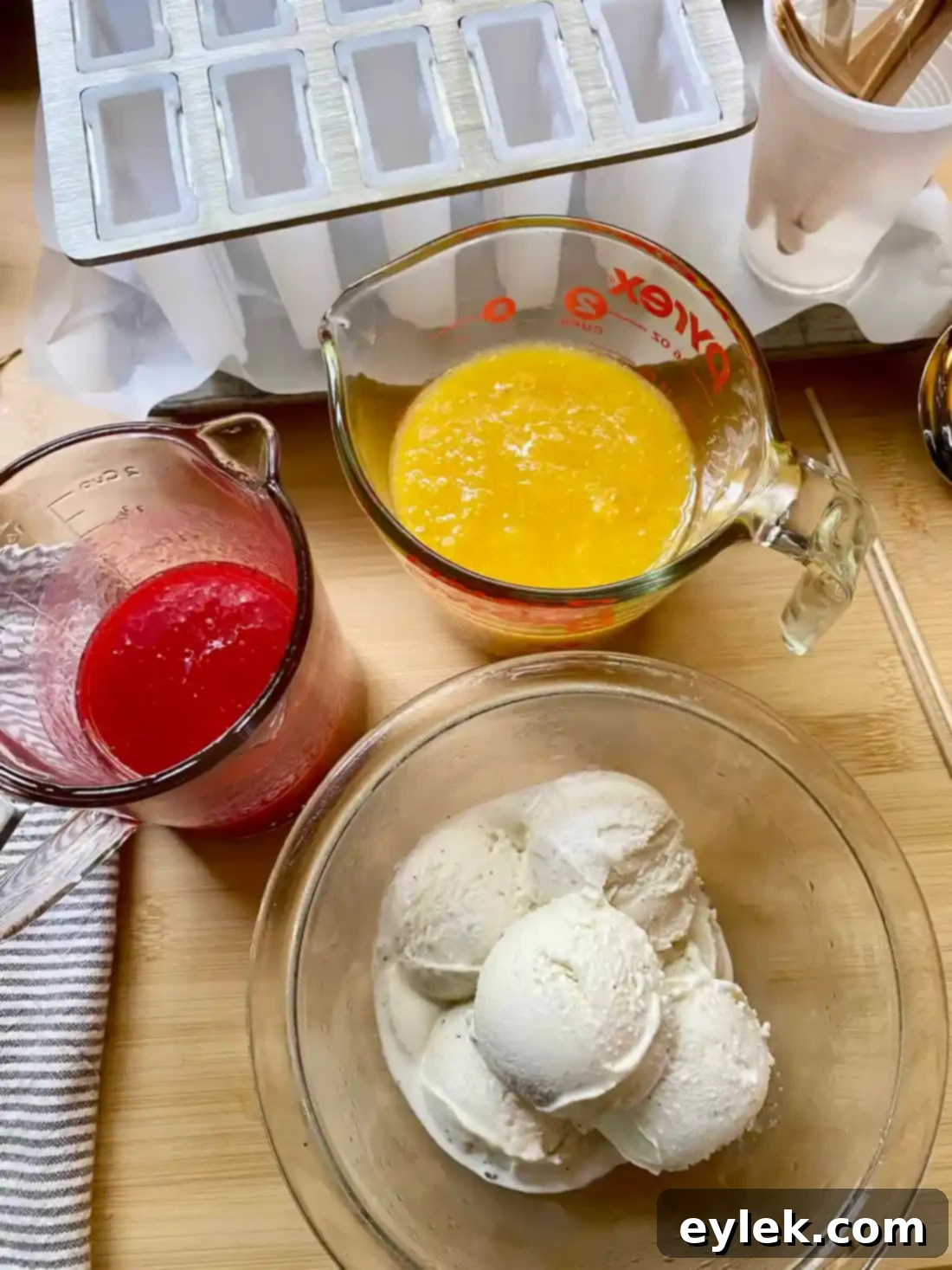 Popsicle molds laid out with ingredients ready for assembly