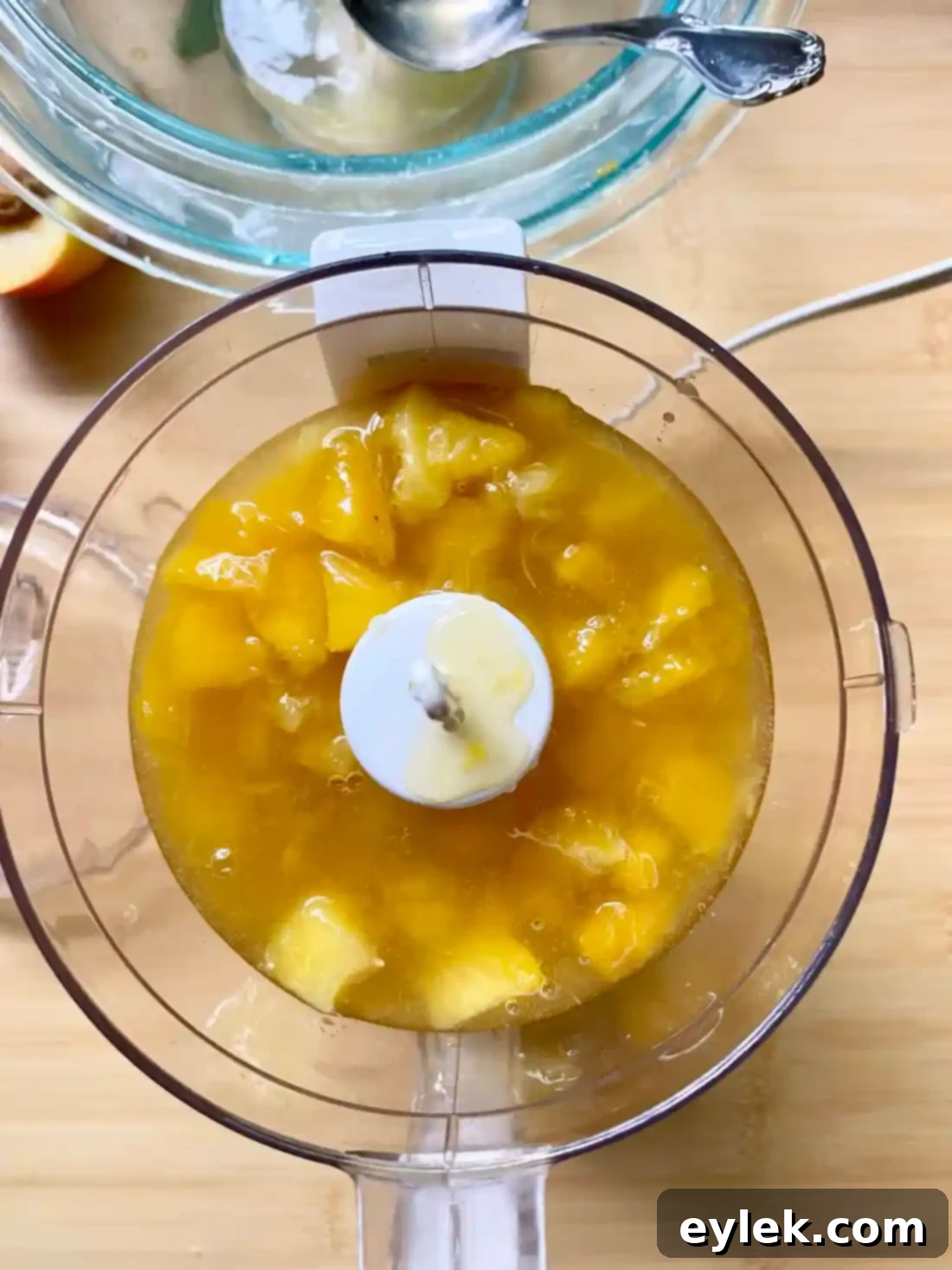 Blending peaches for homemade peach melba popsicles