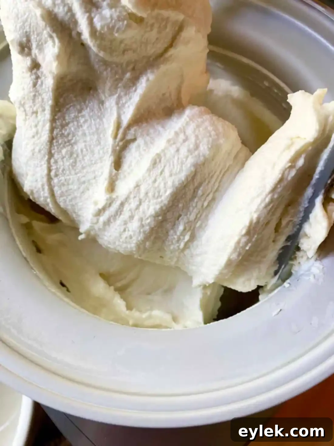 Layering blueberry sauce and graham crackers over ice cream