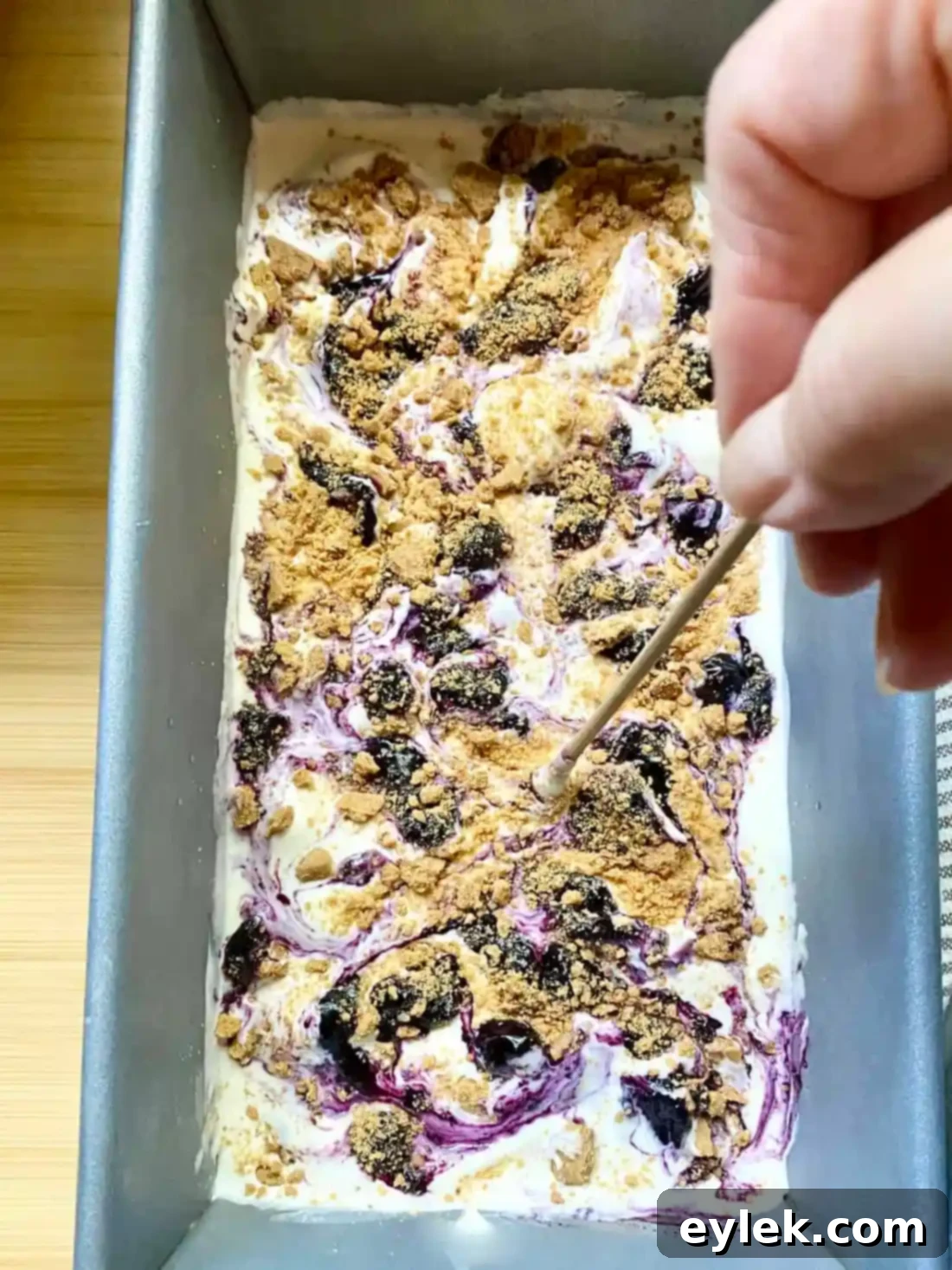 Swirling layers of ice cream, sauce, and crumbs