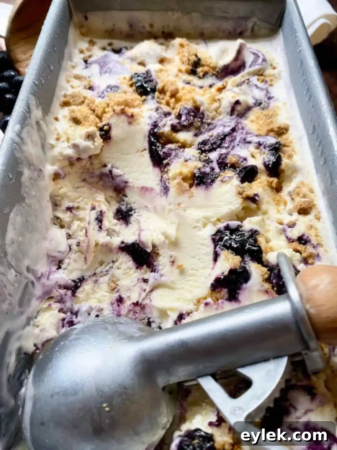 Frozen blueberry cheesecake ice cream in container