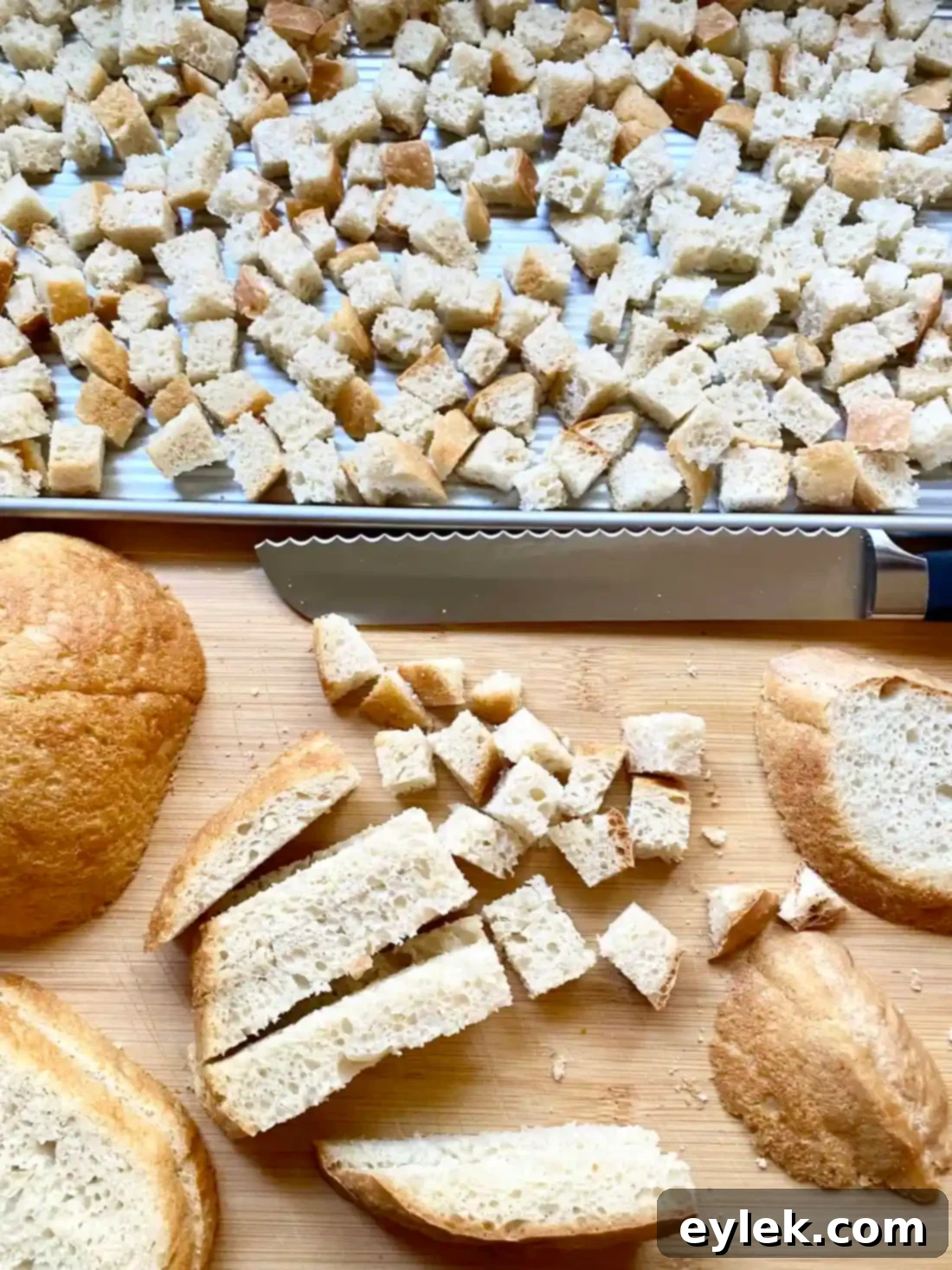 Bread cubes drying on a baking sheet