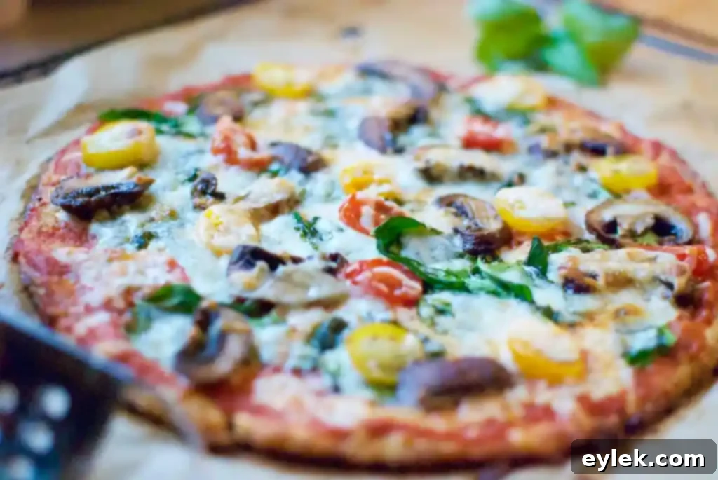 The ultimate cauliflower crust pizza, freshly baked and ready to be sliced, showcasing delicious toppings.