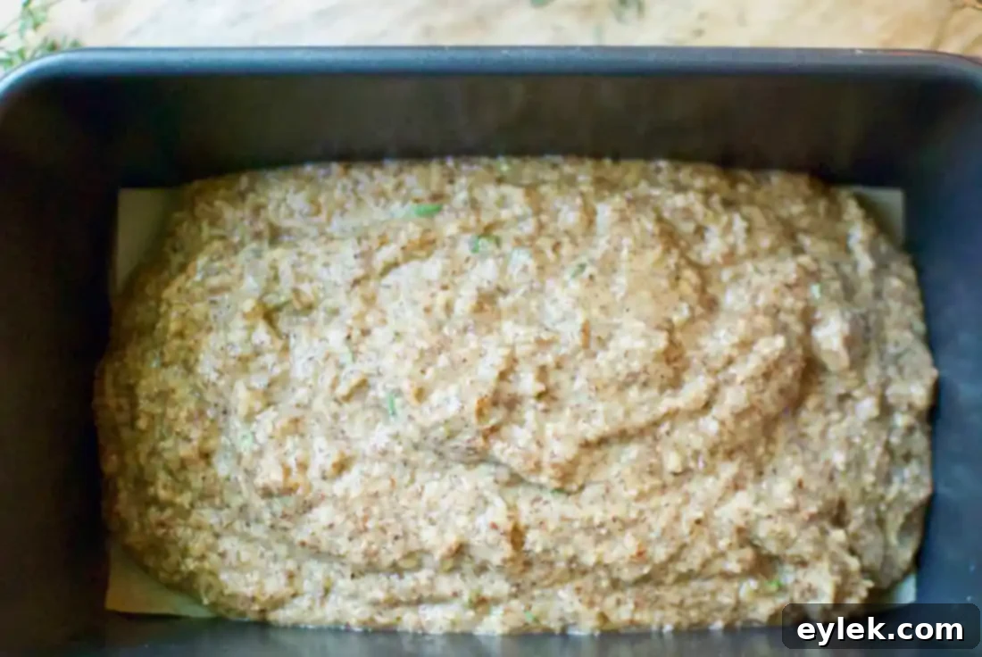 Rosemary & Thyme Almond Bread batter in loaf pan with garnish