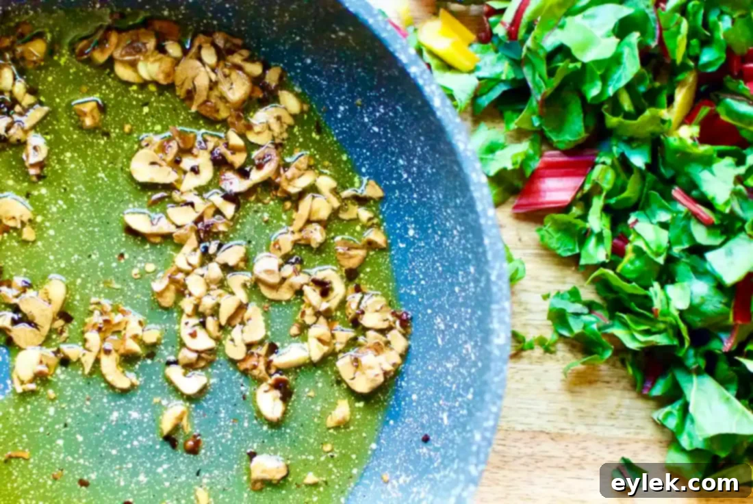 Cooking garlic in olive oil for Aglio E Olio sauce.