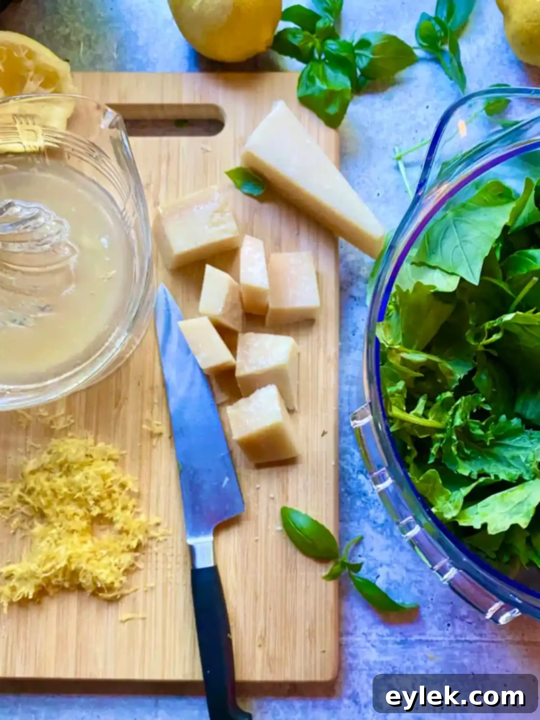 Parmesan cheese cubes, lemon zest, and lemon juice added to the food processor with the greens.