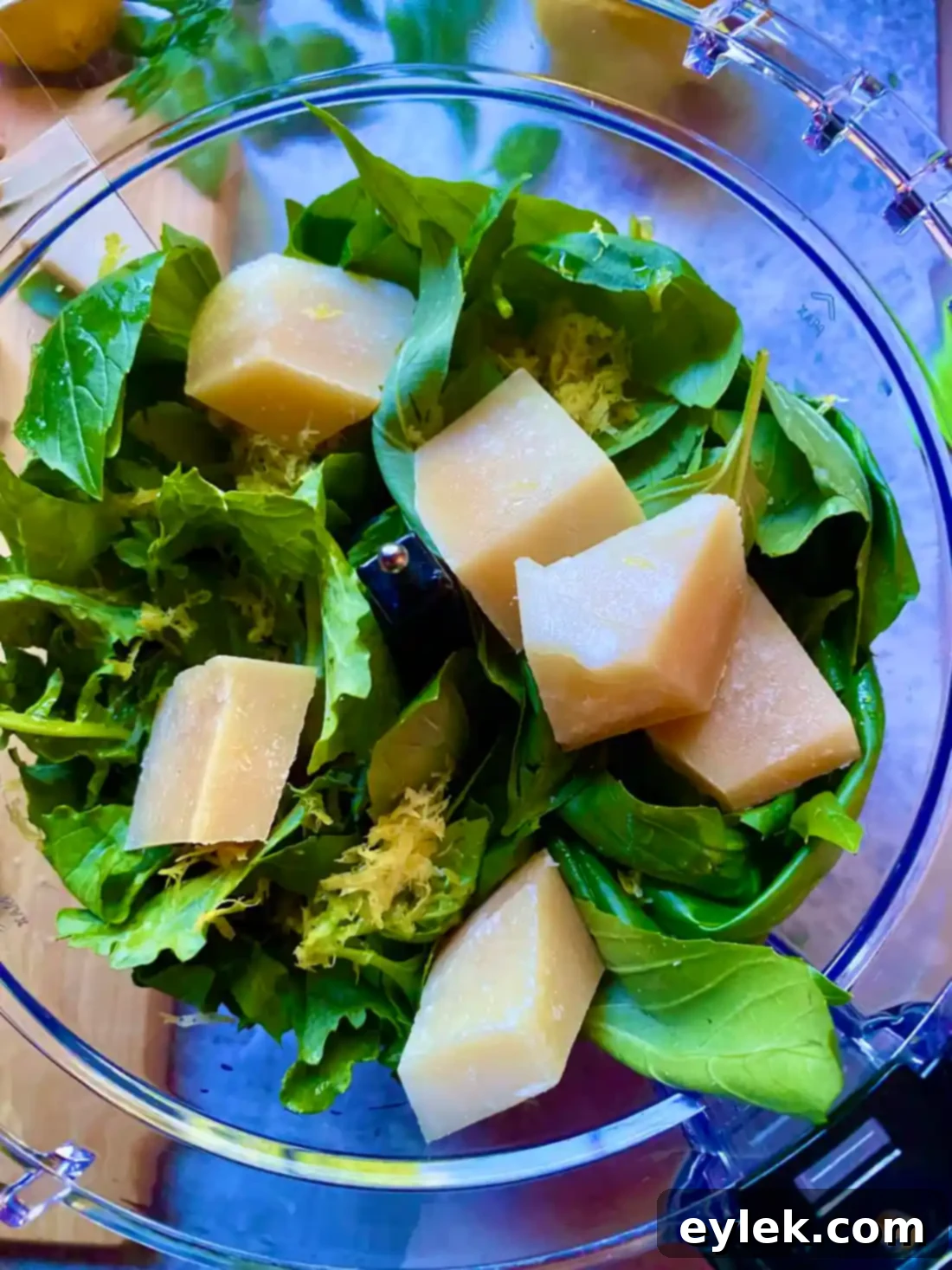 Broccoli rabe pesto ingredients after initial pulsing, showing coarse texture before adding olive oil.