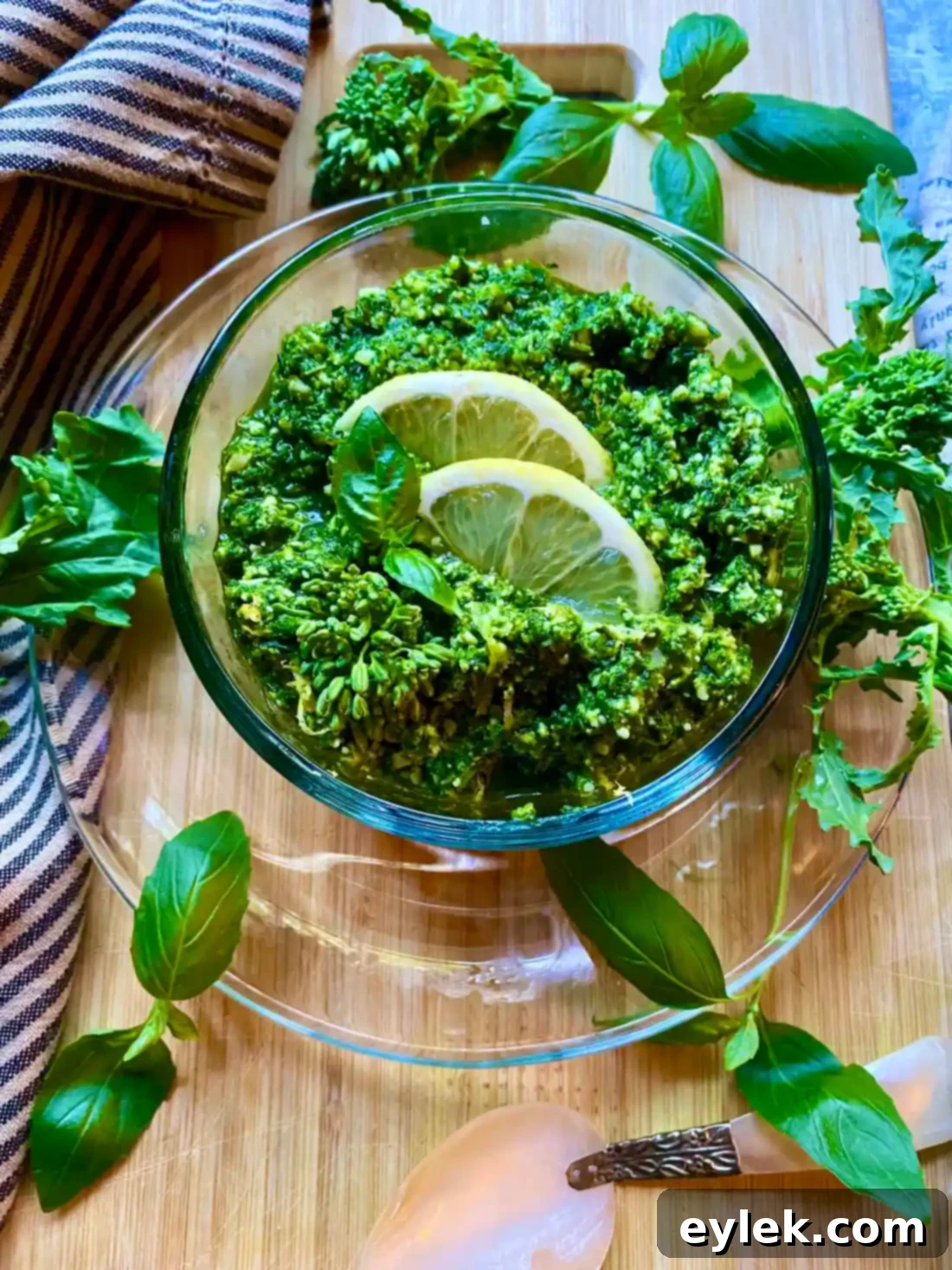 A close-up of a spoonful of vibrant Broccoli Rabe & Lemon Pesto, showing its texture.