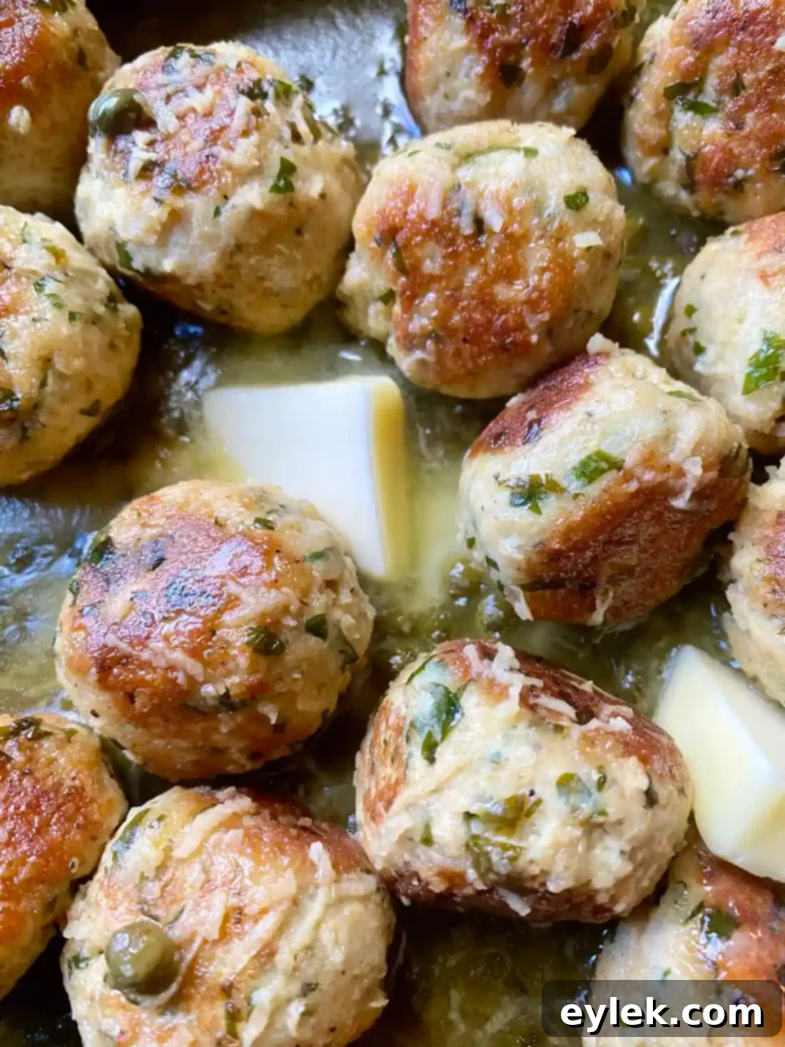 Zesty Chicken Piccata Meatballs 15 Stirring butter into the sauce